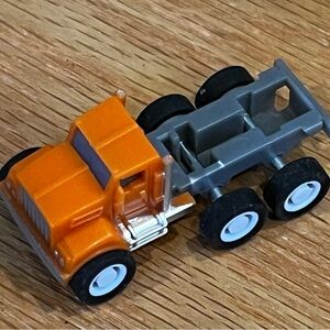 Bright Orange Toy Truck with Black and Gray Wheels
